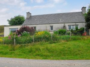 a house on the side of a road at Lower Brae in Achnahanat