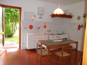 a kitchen with a table and a sink and a stove at B&B Cuei di Baret in Tricesimo
