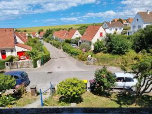 a village with houses and cars parked on a street at Kaly in Audinghen