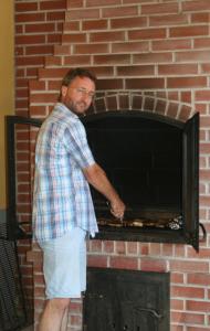 a man standing in front of a brick oven at Pension Schlossblick in Nebersdorf