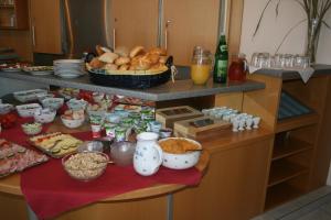a kitchen with a table with food on it at Pension Schlossblick in Nebersdorf
