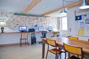 a room with a table and chairs and computers on the wall at Oasis in Antibes