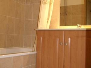 uma casa de banho com uma banheira, um lavatório e um espelho. em Appartement Les Adrets-Prapoutel, 3 pièces, 6 personnes - FR-1-557-121 em Les Adrets