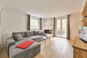 a living room with a couch and a tv at Apartmenthaus Steiner in Lech am Arlberg