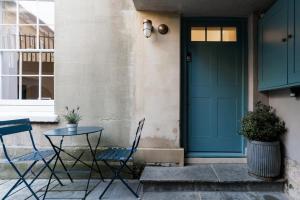 a table and chairs in front of a door at Berkeley Square Apartment in Bristol