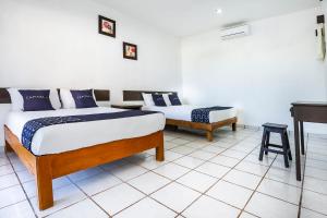 Postel nebo postele na pokoji v ubytování Capital O Oxtankah,chetumal bay