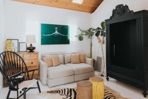 a living room with a couch and a chair at Senhora do Cabo Meco Homy Holidays in Sesimbra