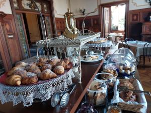a buffet of bread and pastries on a table at Villa Tina Hotel in Viareggio