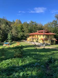 a large house in the middle of a field at Вила Ренесанс Костенец in Kostenets