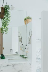 a bathroom with white marble countertops and plants at Senhora do Cabo Meco Homy Holidays in Sesimbra