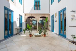 a courtyard with potted plants in a building at Hotel Albaicín - Auto Check-in in Coín