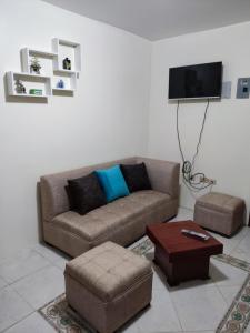 a living room with a couch and a tv at Dulce Hogar 02 in Loja