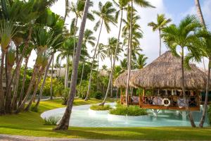 a resort with a pool and palm trees at Impressive Punta Cana - All Inclusive in Punta Cana