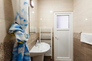 een badkamer met een wastafel, een toilet en een raam bij Pensiunea Agroturistica Rares in Cluj-Napoca