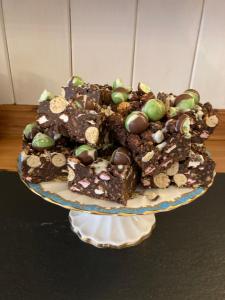 a plate with three pieces of chocolate fudge and eggs at Maple Bank Country Guest House in Keswick