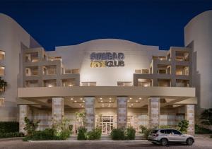 a building with a car parked in front of it at Sindbad Club in Hurghada