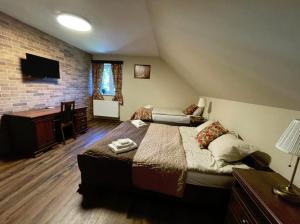 a bedroom with two beds and a television in a room at Room Mesi in Rozvadov