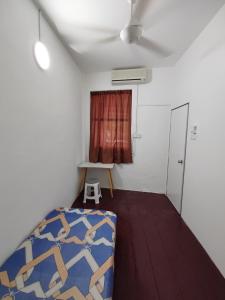 a small room with a bed and a window at Hutton Lane Hostel Georgetown in George Town