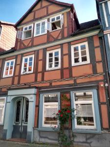 a brown and white house with white windows at Damm 10 Appartement in Peine