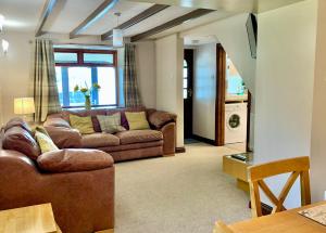 a living room with a couch and a table at Bracknell Cottage in Freystrop