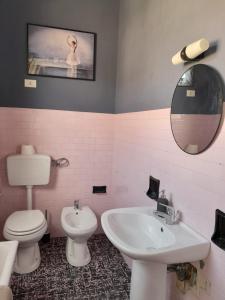 a bathroom with a sink and a toilet and a mirror at Ballerina Bianca bed & breakfast in Grottazzolina