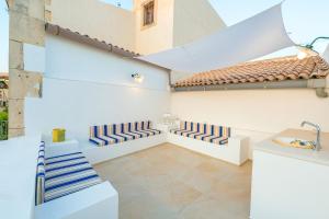a living room with white walls and a sink at Veronique by Dimore in Sicily in Siracusa