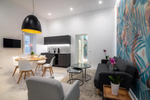 a living room with a couch and a table at Frida apartments by Dimore in Sicily in Siracusa