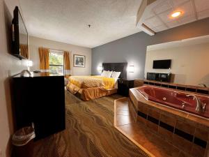 a hotel room with a bed and a bath tub at SureStay Hotel by Best Western Morganton in Morganton