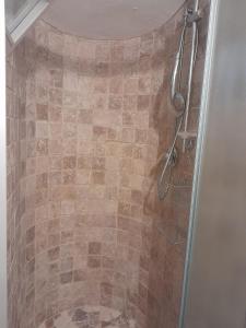 a bathroom with a shower with a glass door at Ballerina Bianca bed & breakfast in Grottazzolina