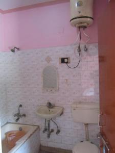 a bathroom with a sink and a toilet and a tub at Hotel Sagar in Agra