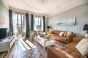 a living room with a couch and a tv at Habitat Apartments Grace in Barcelona