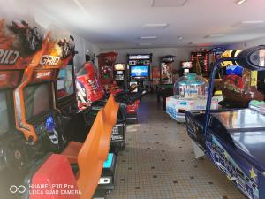 ein Arcade-Zimmer mit Videospielen und Spielautomaten in der Unterkunft Camping SIBLU - La réserve in Gastes
