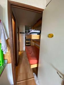 a small room with a couch in a tiny house at Laye station - les Arolles A - 4 personnes in Laye