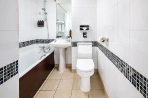 a bathroom with a toilet and a sink at Mercure Glasgow City Hotel in Glasgow