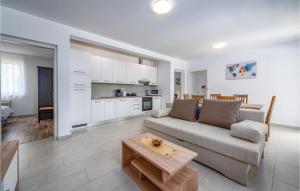 a living room with a couch and a table at Lovely Home In Zminj With Kitchen in Žminj