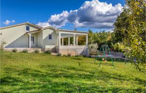 a house with a yard with a swing at Lovely Home In Zminj With Kitchen in Žminj +31 photos