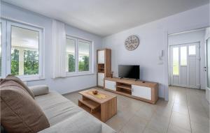 a living room with a couch and a tv at Lovely Home In Zminj With Kitchen in Žminj