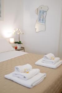 ein Schlafzimmer mit zwei weißen Handtüchern auf einem Bett in der Unterkunft Trastevere Chic and Smart Loft in Rom