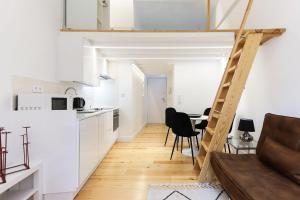 a kitchen and dining room with a loft conversion at CHARMING SANTOS by Homing in Lisbon
