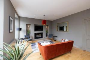 salon z kanapą i kominkiem w obiekcie ALTIDO Stylish 2-bed flat in New Town w Edynburgu