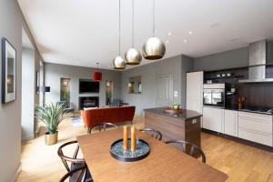 a kitchen and dining room with a table and chairs at ALTIDO Stylish 2-bed flat in New Town in Edinburgh