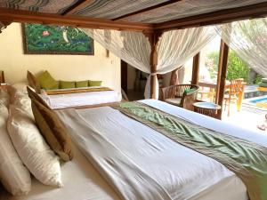 a large bed in a room with a window at Villa Agung Khalia Ubud in Ubud