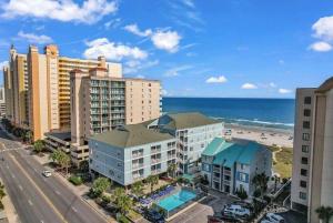 an aerial view of a beach with buildings and the ocean at Stunning 8 BR, New Updates, Walk to Beach Bars, Main Street in Myrtle Beach