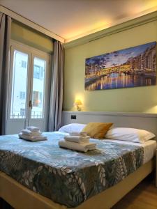 Postel nebo postele na pokoji v ubytování Hotel Camilla Firenze