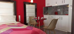 a bedroom with a bed and a table with chairs at Spiros Rooms in Kastrosikia