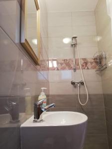 een badkamer met wastafel en douche bij Liberty Apartman Bükfürdő in Bük +14 foto's