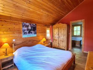 a bedroom with a bed in a log cabin at Chalet spacieux à Flaine avec sauna, cheminée et balcon - 6 chambres, proche des pistes - FR-1-425-4 in Flaine