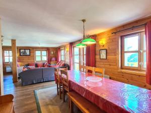 a dining room with a table and a living room at Chalet spacieux à Flaine avec sauna, cheminée et balcon - 6 chambres, proche des pistes - FR-1-425-4 in Flaine