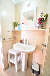 a bathroom with a sink and a mirror at Rent for Days III - Mono Plaza in San Miguel de Tucumán