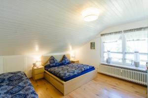 a bedroom with two beds and a window at Ferienwohnungen Am Skilift in Herrischried +71 photos